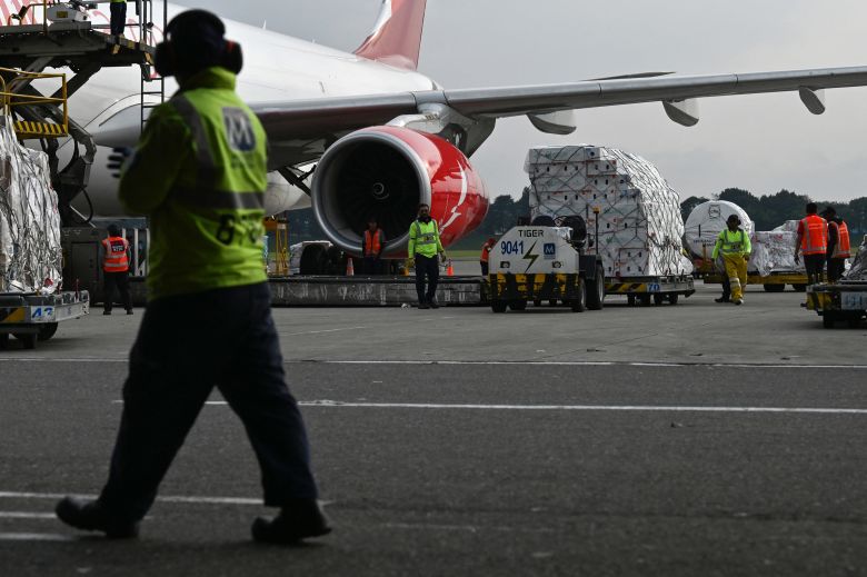 Workers arrange boxes of flowers before loading them onto a cargo plane for export at El Dorado International Airport in Bogota on Tuesday.