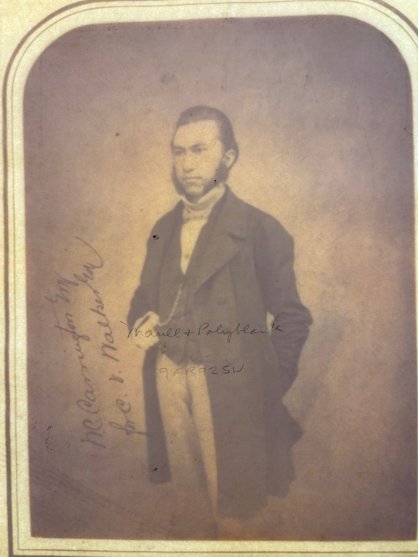 Placed face down on top of a light box, the photo reveals an inscription.