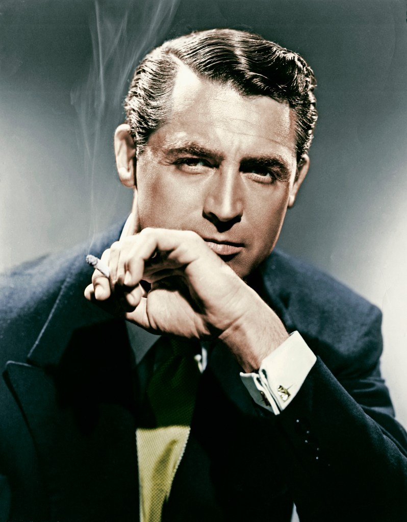 Cary Grant smoking a cigarette, looking directly at the camera.