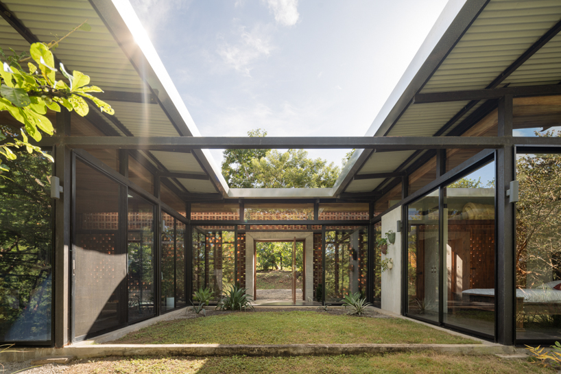 a series of porous brick partitions enclose central garden within costa rica residence