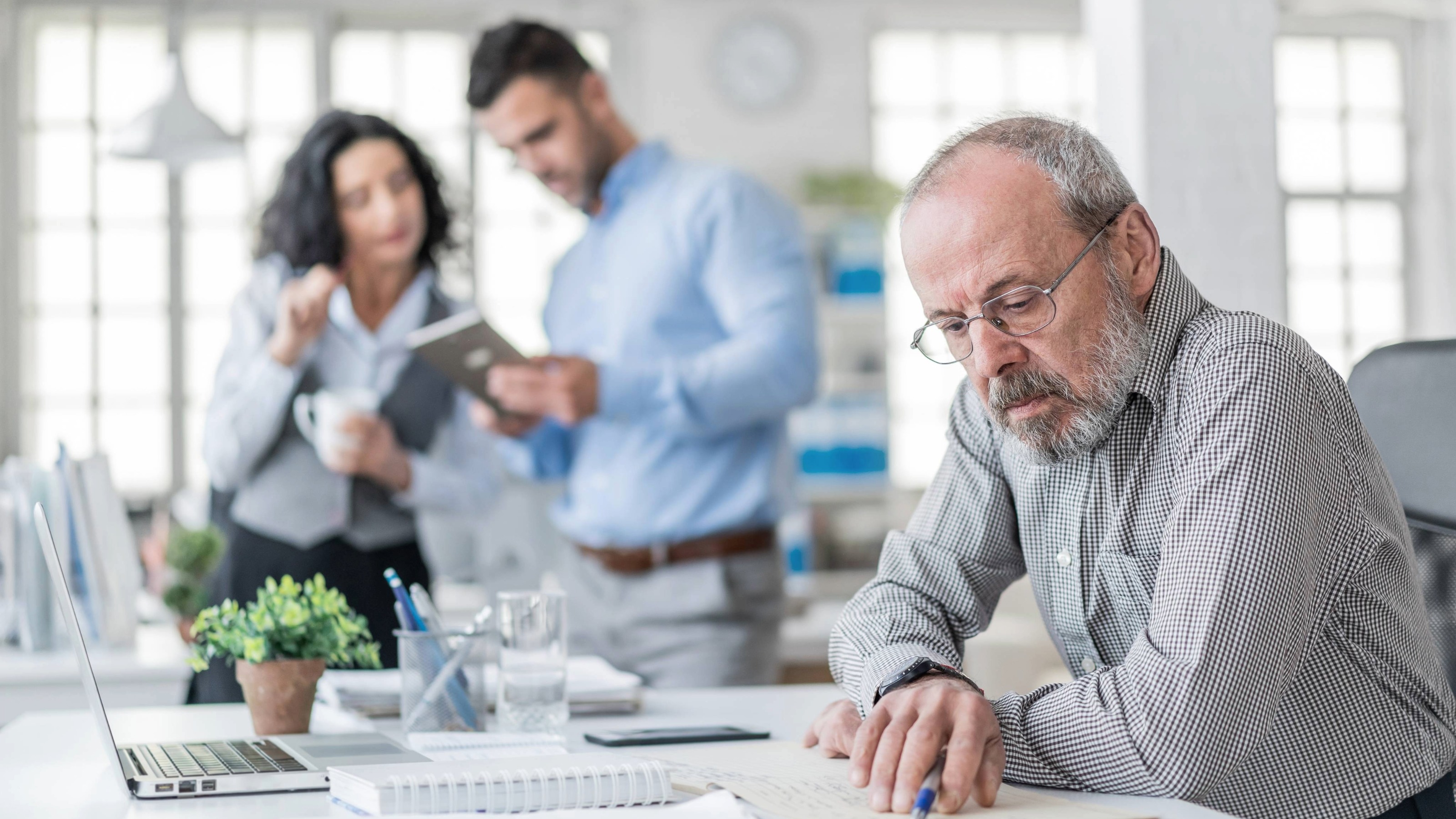 A senior businessman working in his modern office