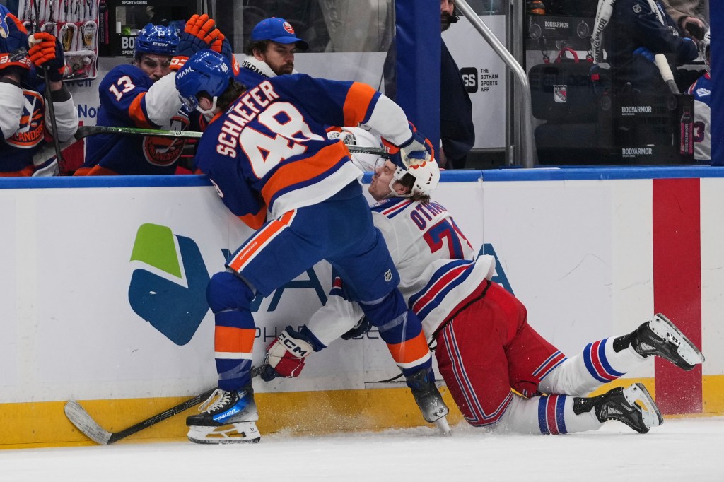 New York Islanders' Matthew Schaefer (48) checks New York Rangers' Brennan Othmann (78) during the first period of an NHL hockey game Wednesday, Jan. 28, 2026.