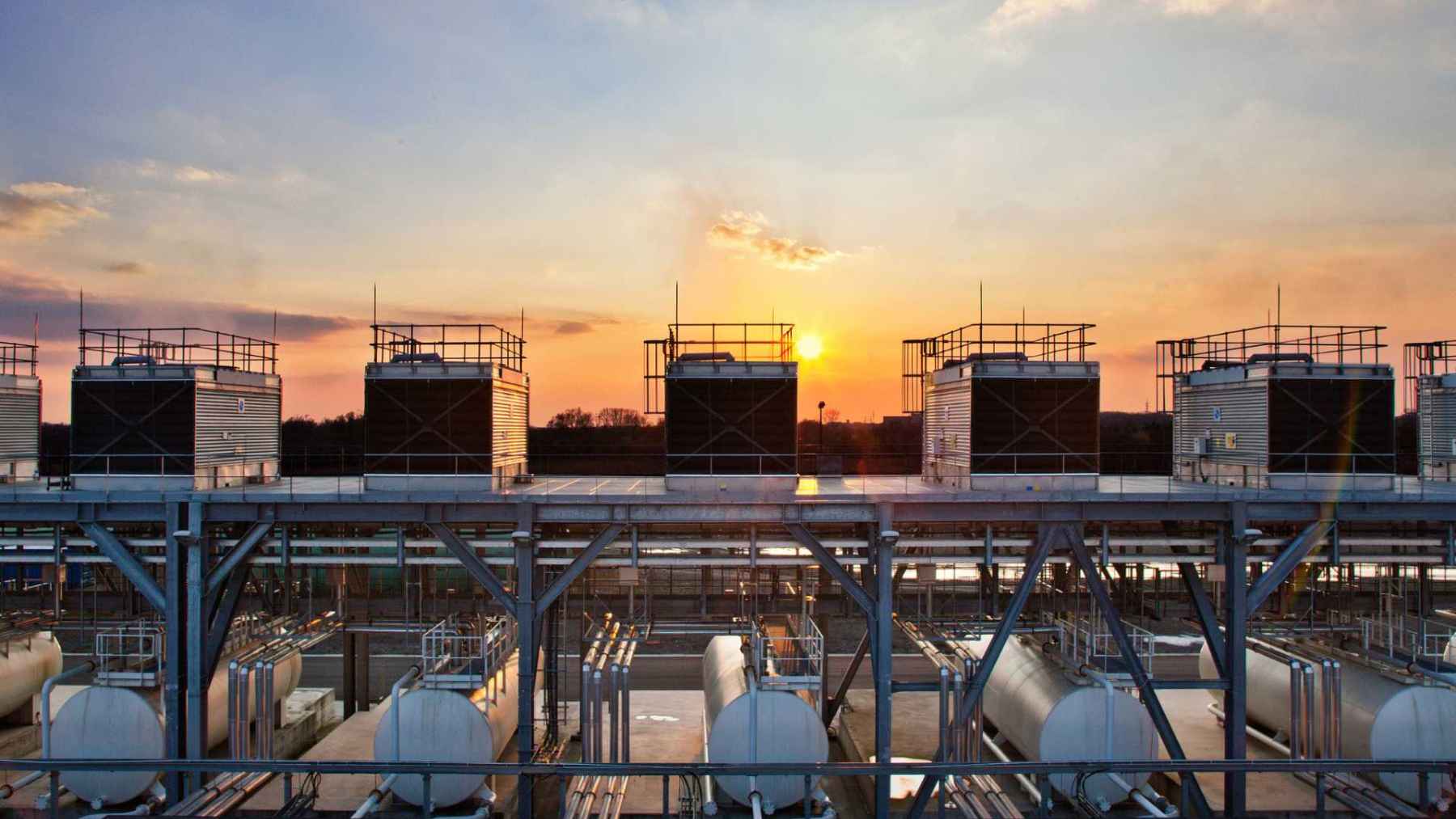 Data center cooling units at sunset, highlighting the energy and water footprint behind today’s AI boom