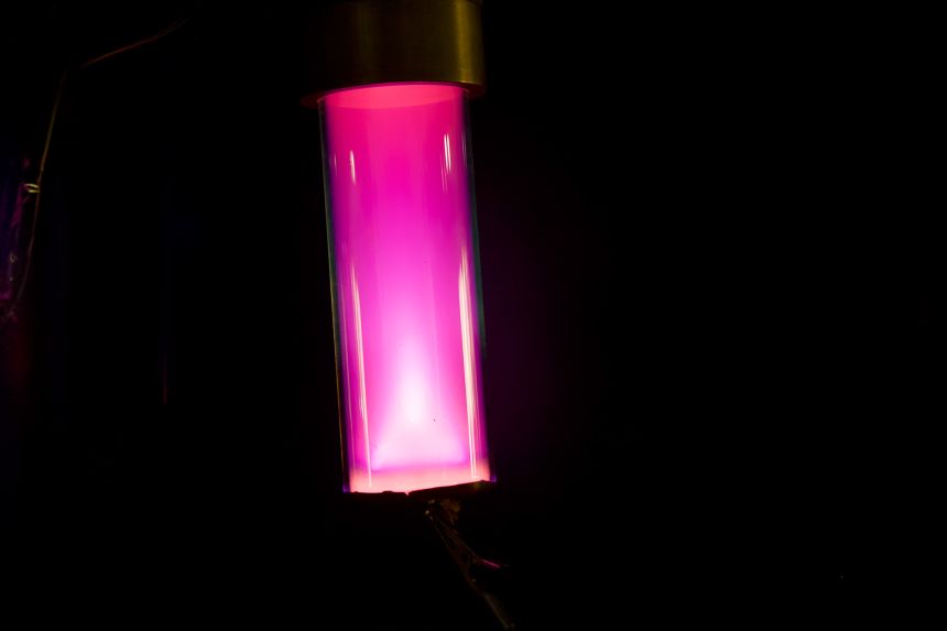 The cosmic dust in a lab consists of a mix of gases that glow different colors when excited by electricity.