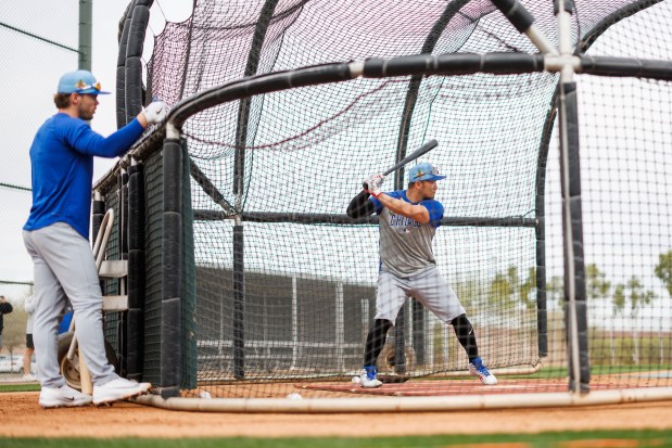 Nico Hoerner watches Seiya Suzuki take batting practice during the first day of the Cubs full-squad workout at spring training at Sloan Park on Feb. 16, 2026, in Mesa, Ariz. (Armando L. Sanchez/Chicago Tribune)