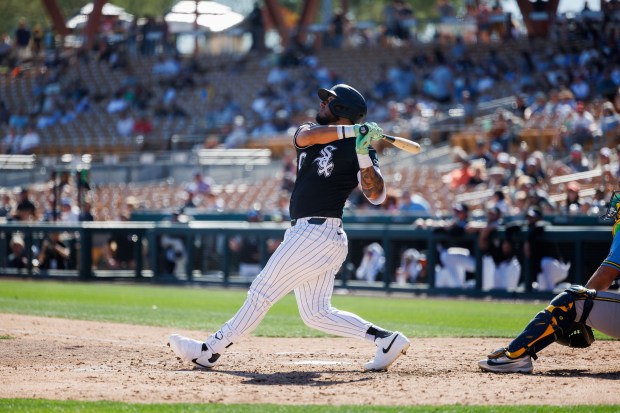 Chicago White Sox second baseman Lenyn Sosa (50) hits a fly-out during the fourth inning against the Milwaukee Brewers in a Cactus League game at Camelback Ranch on Sunday, Feb. 22, 2026, in Glendale, Ariz. (Armando L. Sanchez/Chicago Tribune)