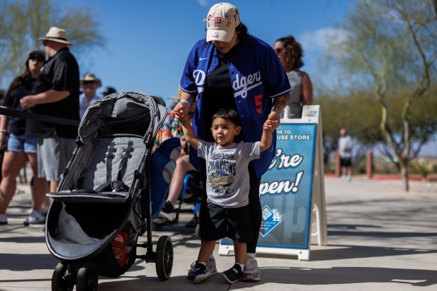 Rachel Garcia and her 2-year-old son Levi Chavez wait in line before the Chicago White Sox play the Milwaukee Brewers in a Cactus League game at Camelback Ranch on Sunday, Feb. 22, 2026, in Glendale, Ariz. (Armando L. Sanchez/Chicago Tribune)