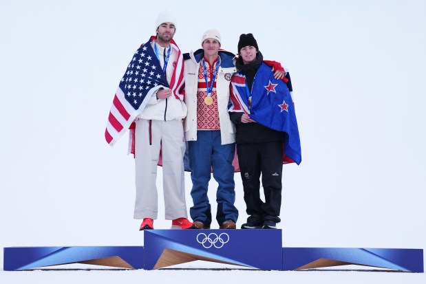 Silver medalist Alex Hall of the United States, from left, gold medalist Birk Ruud of Norway and bronze medalist Luca Harrington of New Zealand celebrate after the men's freestyle skiing slopestyle finals at the 2026 Winter Olympics on Tuesday, Feb. 10, 2026, in Livigno, Italy. (AP Photo/Abbie Parr)