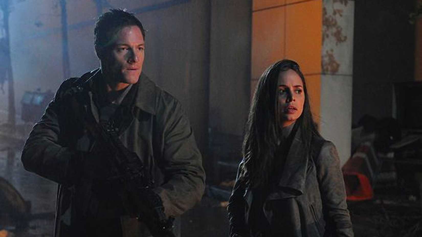 A man and woman looking wary in the cyberpunk series Dollhouse.