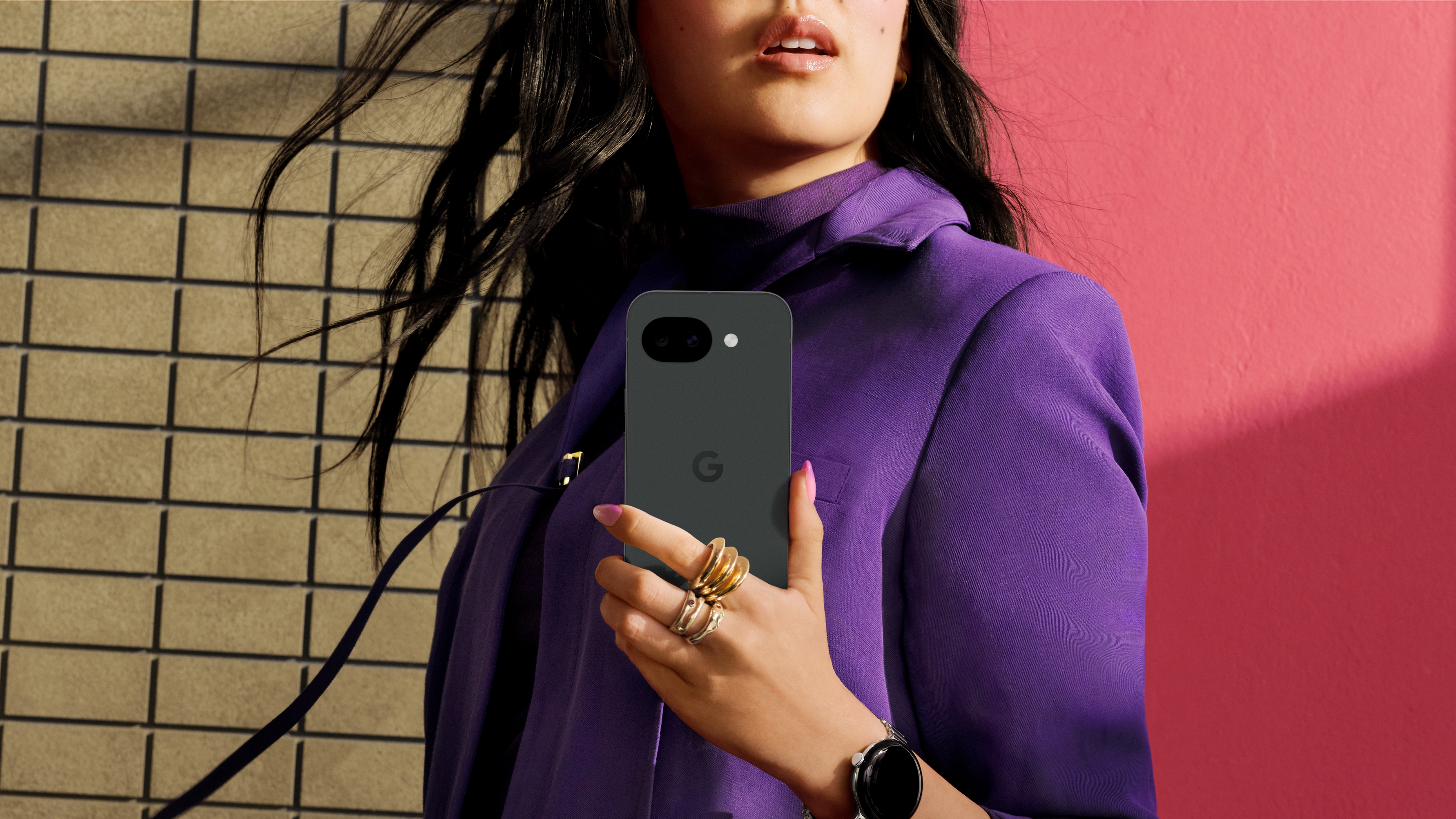 A woman holding the Google Pixel 10a.