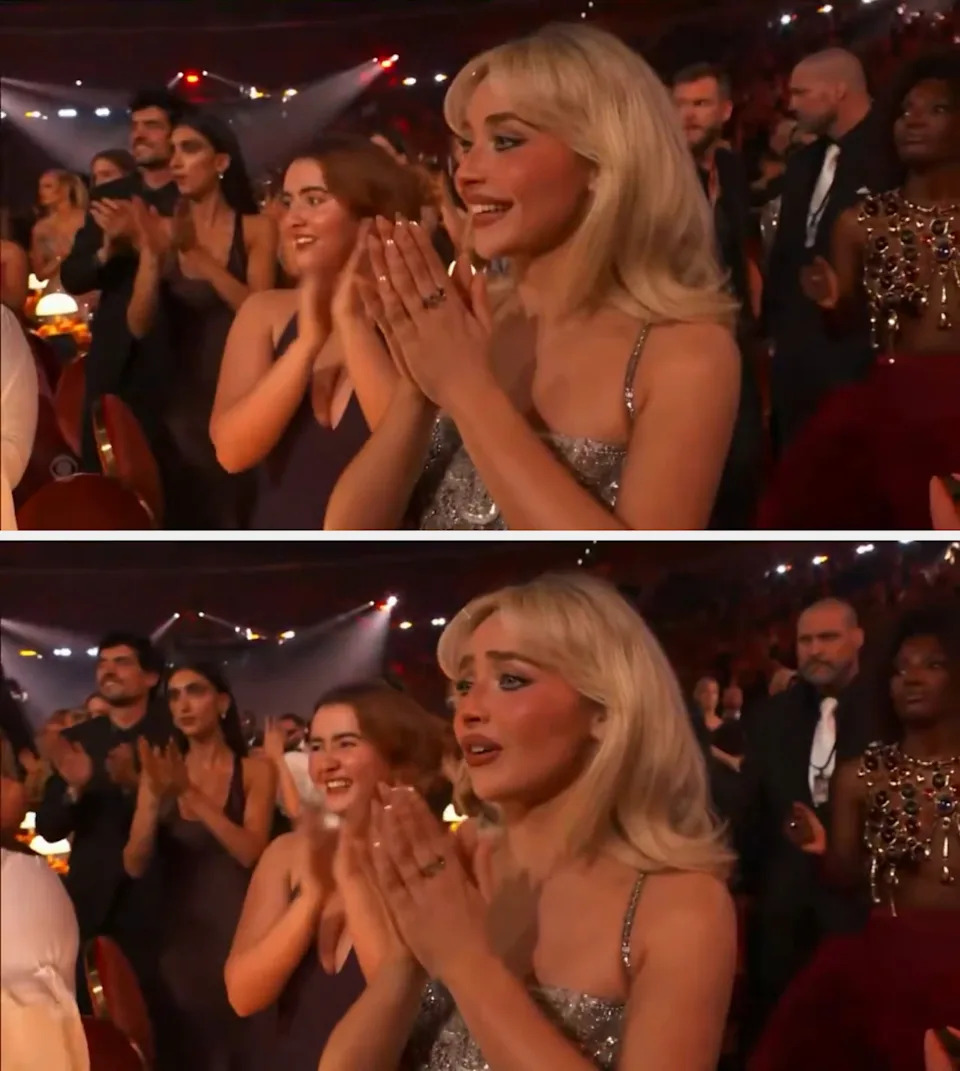 Audience at an event applauding. A person in the foreground with blonde hair is wearing a shimmering dress and clapping enthusiastically