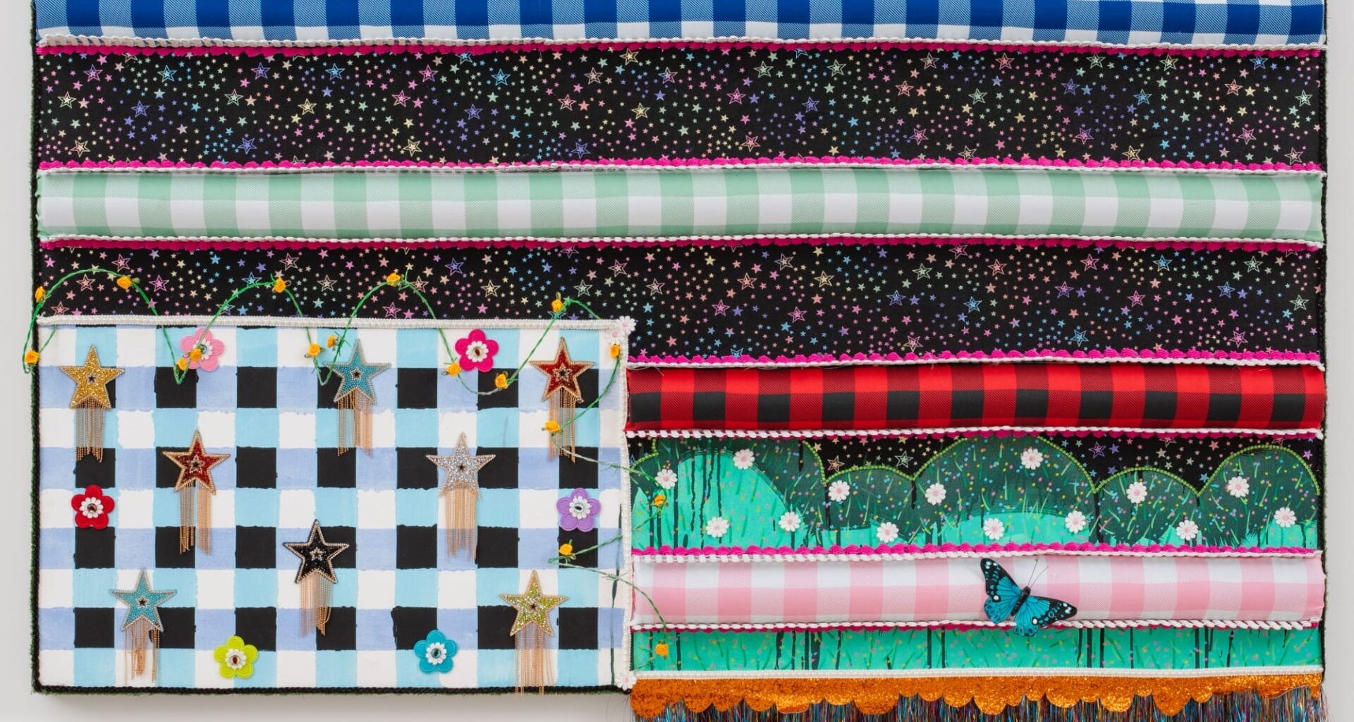 a colorful, patterned textile flag with fringe and glitter by Victoria Dugger