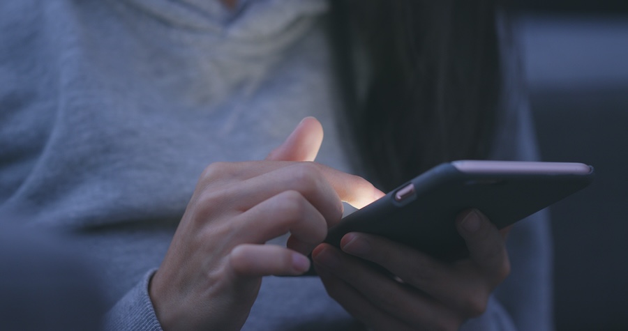 Woman use of mobile phone online