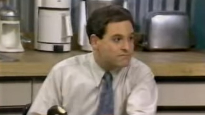 Julian Beeby sitting at a kitcjen table in Everything's Relative