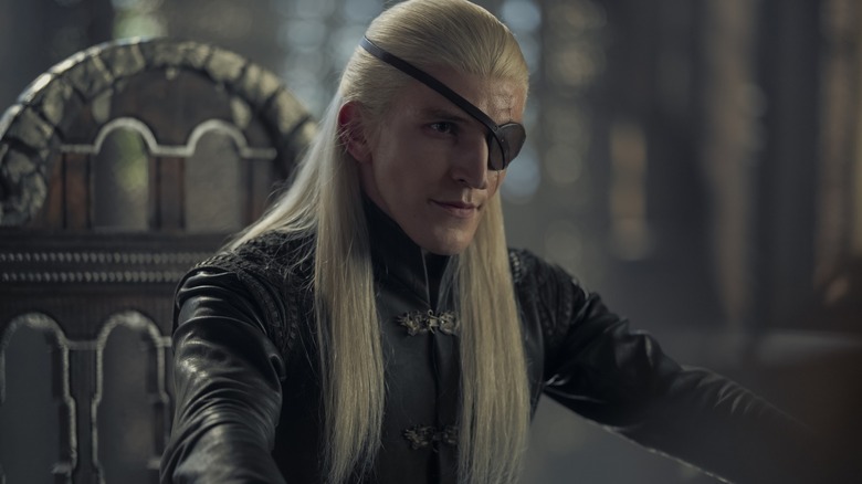 Ewan Mitchell as Aemond sitting at the small council room in House of the Dragon