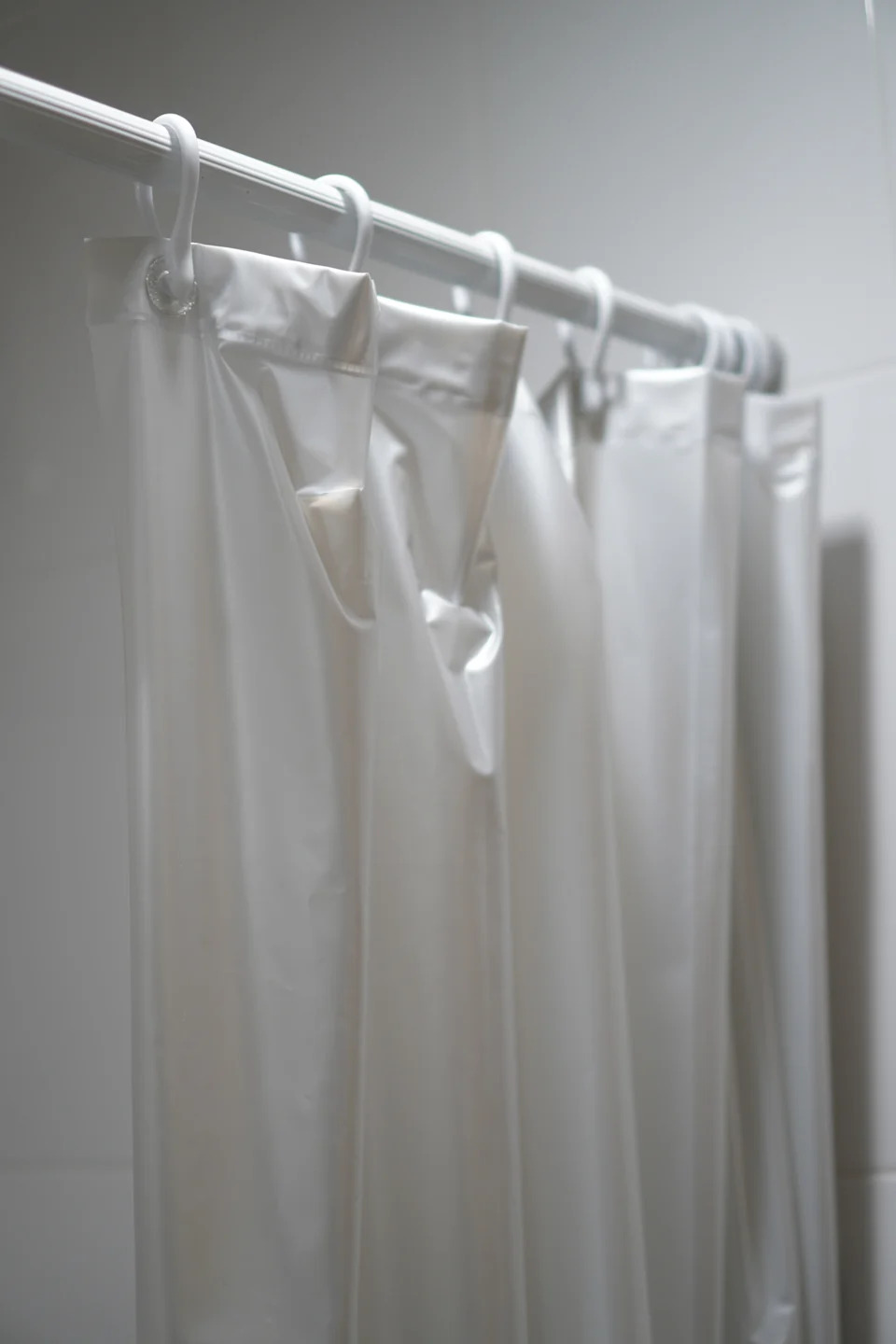 Shower curtain hanging on a rod in a bathroom setting