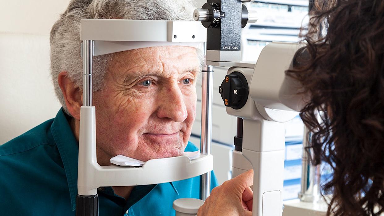 senior man receiving eye exam