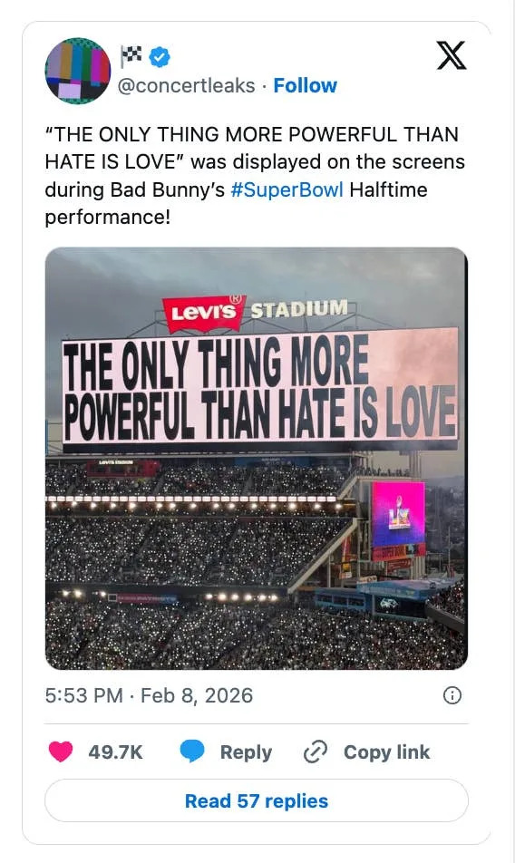 Image showing a Levi's Stadium screen displaying the message: "THE ONLY THING MORE POWERFUL THAN HATE IS LOVE," during a Super Bowl halftime show