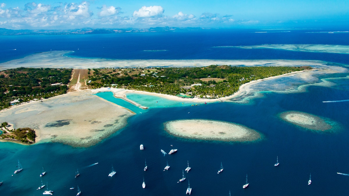 Coral reefs and paradise islands at the Fiji Islands east of Australia seen in the summer in the middle of the pacific Ocean.