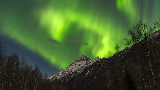 FILE: Northern lights (Aurora Borealis) illuminate the sky in Alaska's Eklutna Tailrace, United States on March 09, 2025.