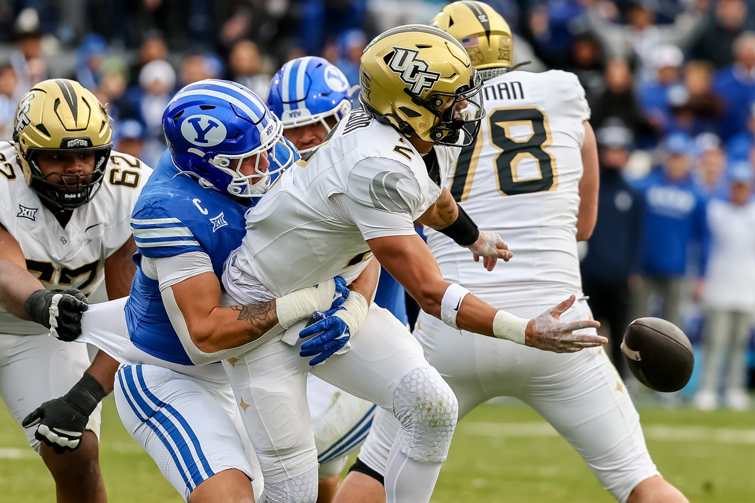 PROVO, UTAH - NOVEMBER 29: Tayven Jackson #2 of the UCF Knights gets rid of the ball before being tackled by Jack Kelly #17 of the BYU Cougars during the second half of the game between UCF Knights and Brigham Young Cougars at LaVell Edwards Stadium on November 29, 2025 in Provo, Utah. (Photo by Bryan Byerly/ISI Photos/ISI Photos via Getty Images)
