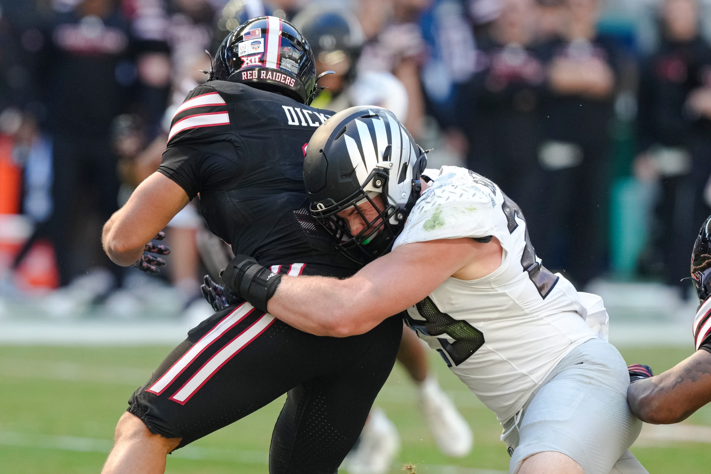 MIAMI GARDENS, FLORIDA - JANUARY 1: Bryce Boettcher #28 of the Oregon Ducks tackles Cameron Dickey #8 of the Texas Tech Red Raiders during the second quarter in the College Football Playoff Quarter Final Game at Hard Rock Stadium on January 1, 2026 in Miami Gardens, Florida. (Photo by CFP/Getty Images)