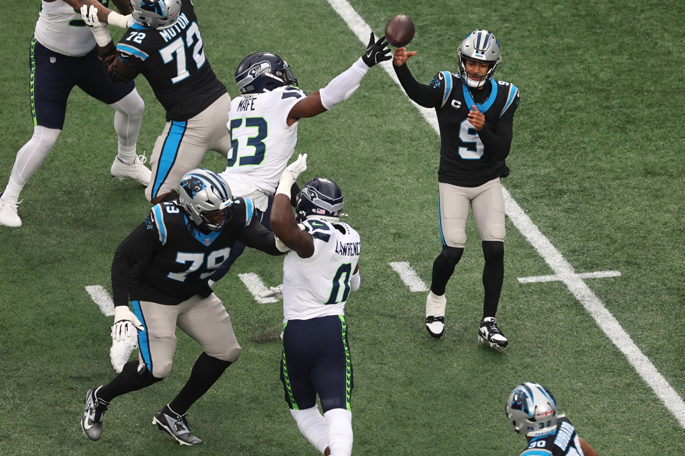 CHARLOTTE, NORTH CAROLINA - DECEMBER 28: Bryce Young #9 of the Carolina Panthers throws a pass in front of Boye Mafe #53 of the Seattle Seahawks during the first quarter at Bank of America Stadium on December 28, 2025 in Charlotte, North Carolina. (Photo by David Jensen/Getty Images)