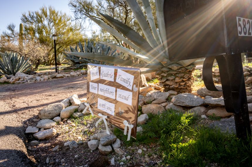 A message of support is seen on a sign posted at the house of Nancy Guthrie in Catalina, Arizona, on Tuesday.