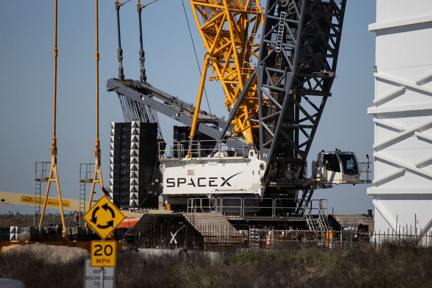 A crane, marked by the SpaceX logo, sits near the Starbase launch site in Cameron County, Texas, on February 6, 2026.
