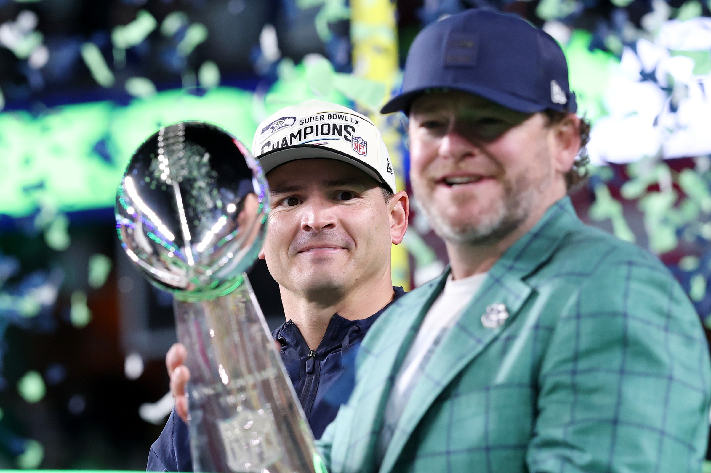 SANTA CLARA, CALIFORNIA - FEBRUARY 08: Head coach Mike MacDonald of the Seattle Seahawks looks on as John Schneider, General Manager of the Seattle Seahawks, celebrates with the Vince Lombardi Trophy after winning Super Bowl LX against the New England Patriots at Levi’s Stadium on February 08, 2026 in Santa Clara, California. The Seattle Seahawks defeated the New England Patriots 29-13. (Photo by Kevin C. Cox/Getty Images)