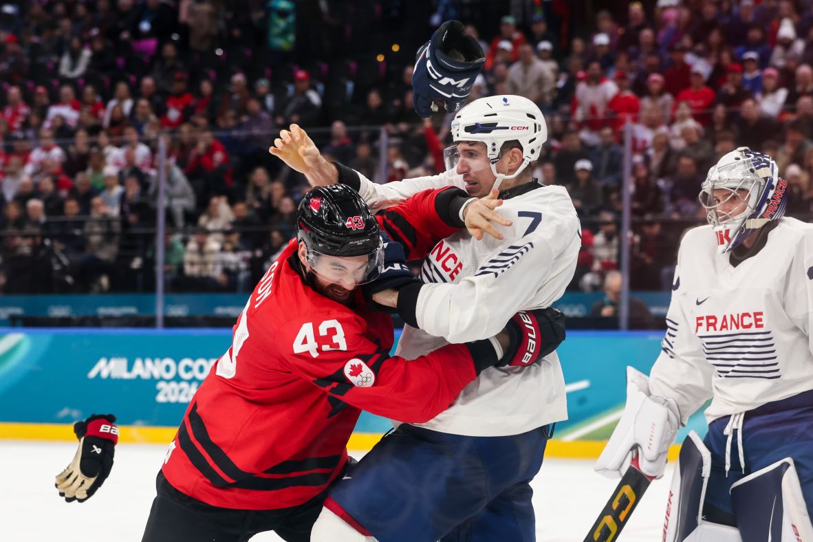 Canada's Tom Wilson and France's Pierre Crinon fight in the third period of a game on February 15. Wilson came to the defense of a teammate who was elbowed in the face, <a href=