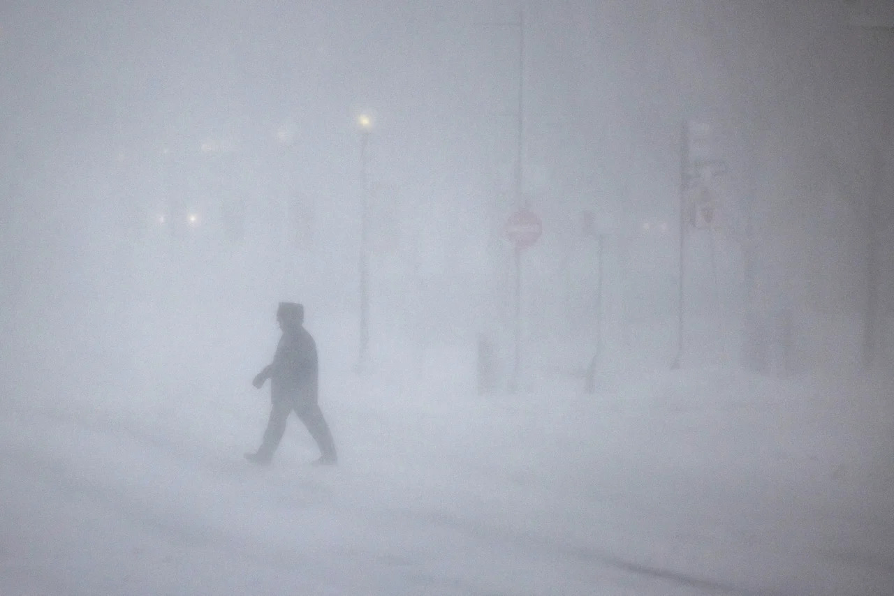 People walk through whiteout conditions on Feb. 23 in Boston, Massachusetts. 