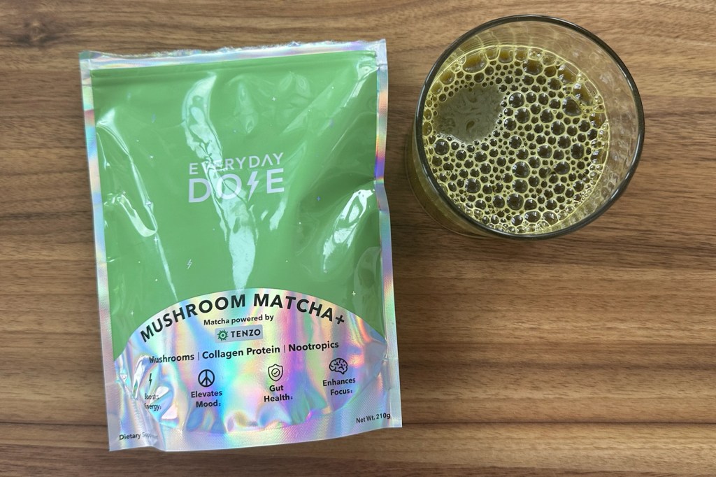 A green bag next to a glass of green liquid