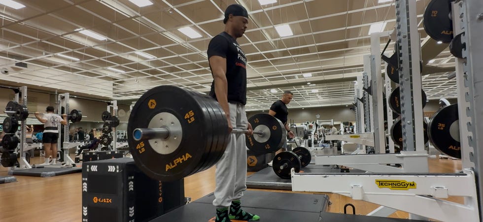 person performing a deadlift in a gym