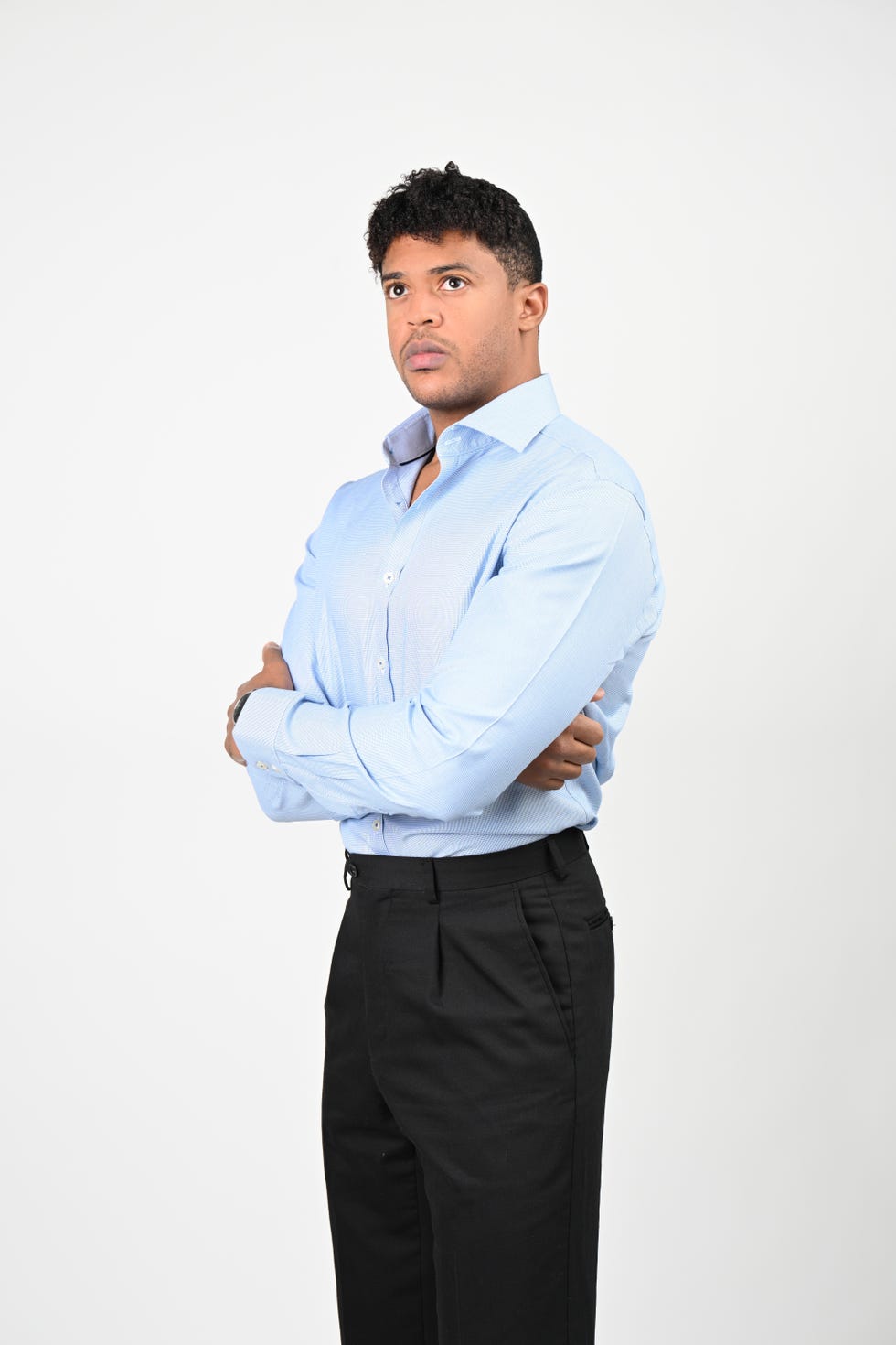 individual posing confidently with arms crossed