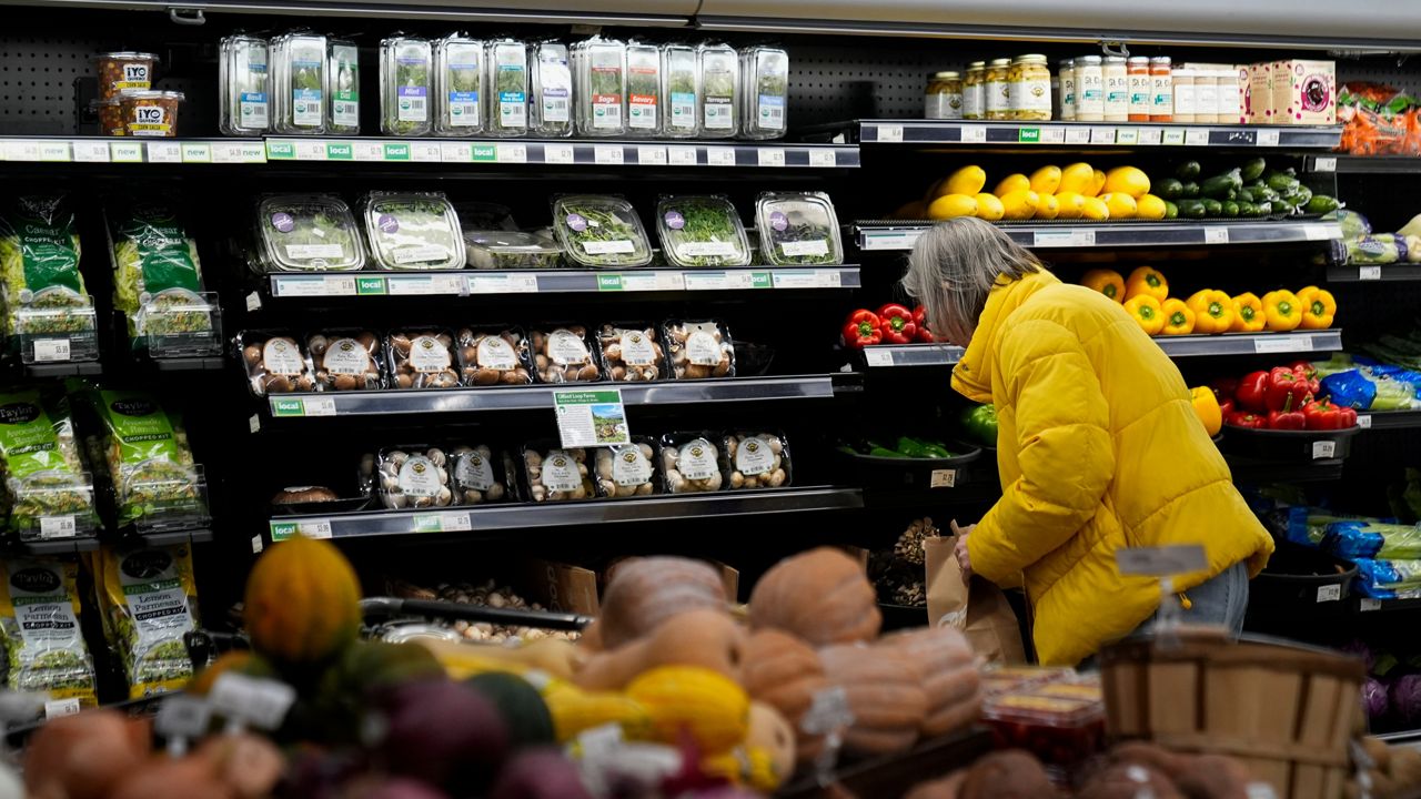 A shopper looks at produce at a grocery store Tuesday, Feb. 10, 2026, in Chicago. (AP Photo/Erin Hooley)