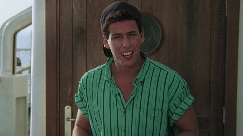 Adam Sandler as Shecky Moskowitz in a green shirt standing in front of a door in Going Overboard