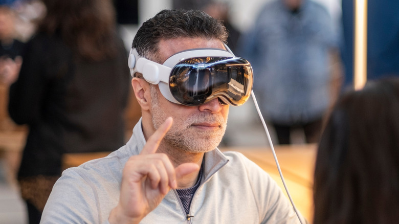 User trying Apple Vision Pro headset and interacting with spatial interface