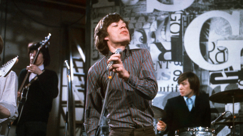 Mick Jagger and Rolling Stones playing on stage in 60s
