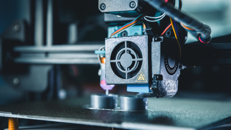 Modern 3d printer producing a new prototype model with melted material in an engineering laboratory