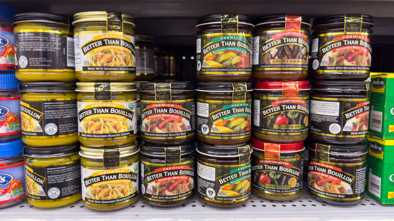 Grocery store display of various Better Than Bouillon jars stacked on shelf