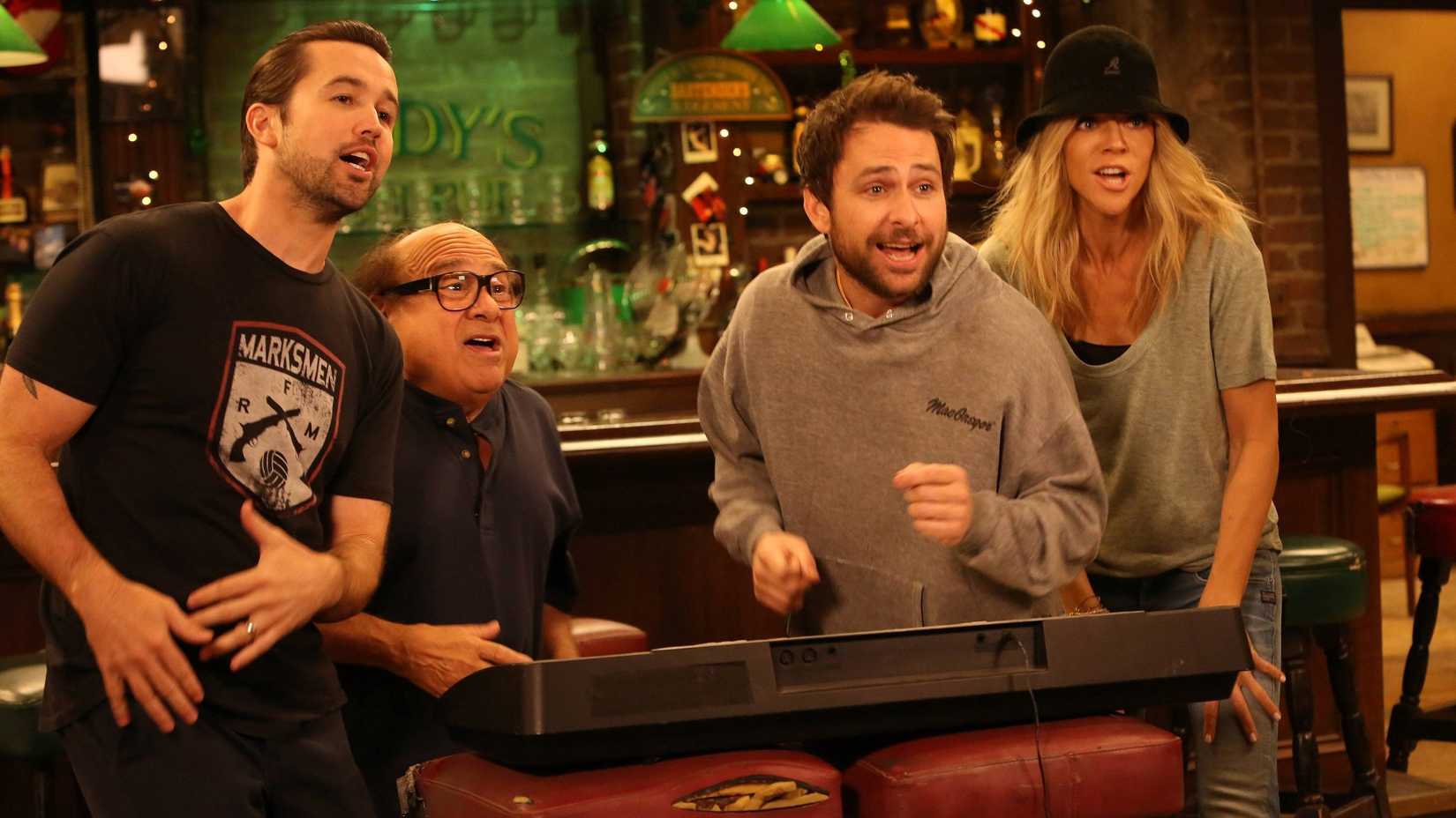Rob McElhenney, Danny DeVito, Charlie Day and Kaitlin Olson watching TV in It's Always Sunny in Philadelphia