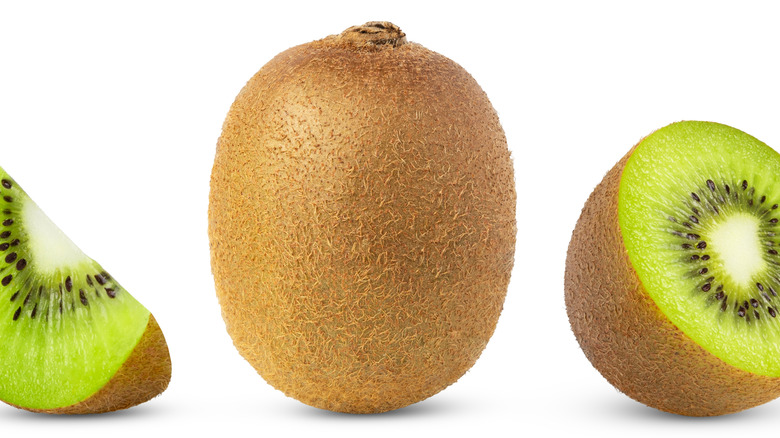 A whole kiwi alongside cut kiwis on a white background