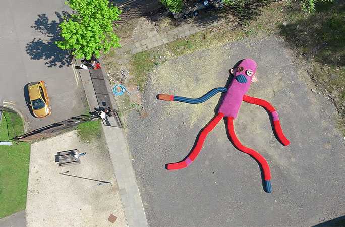 sock monkey on the ground