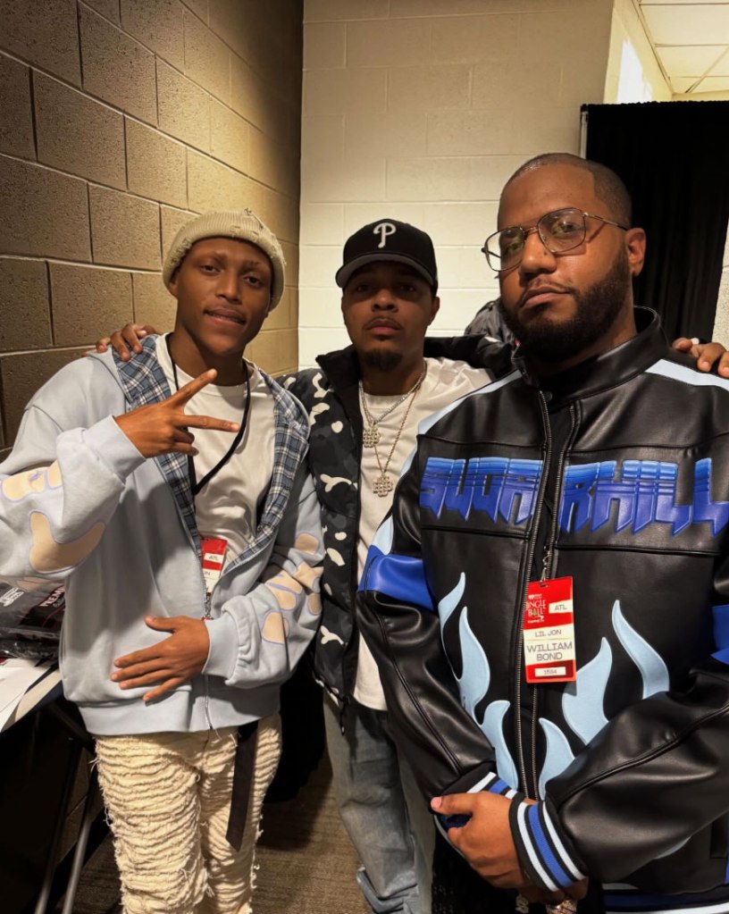Three men, including Lil Bow Wow, pose for a photo.