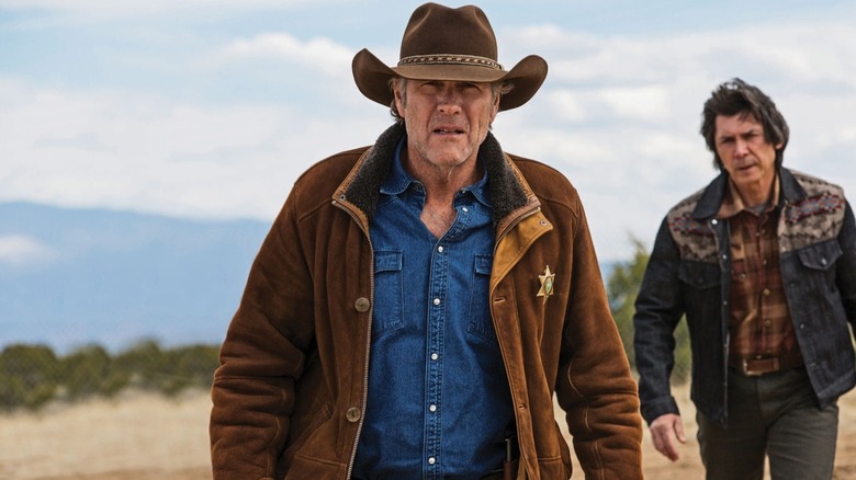 Walt Longmire (Robert Taylor) peers into the horizon while Henry Standing Bear (Lou Diamond Phillips) walks behind him in Longmire