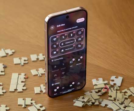 A Pixel 9 Pro open to quick settings, sitting upright among puzzle pieces.