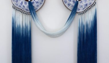 A blue-and-white, ceramic-and-fiber wall artwork by Nicole McLaughlin