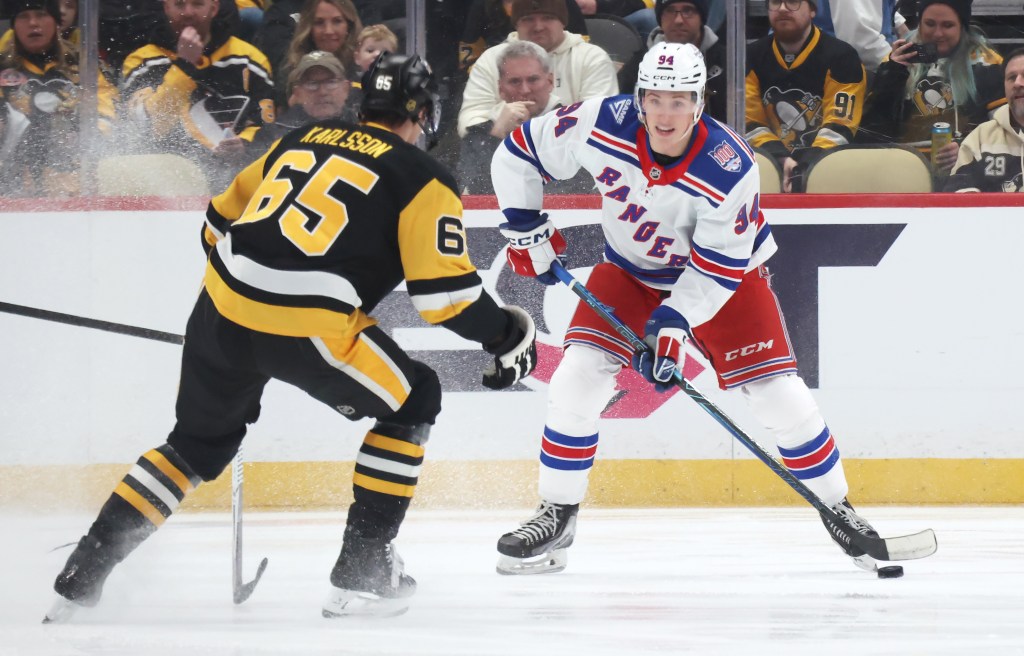 New York Rangers right wing Gabe Perreault (94) handles the puck against Pittsburgh Penguins defenseman Erik Karlsson (65) during the first period at PPG Paints Arena. 