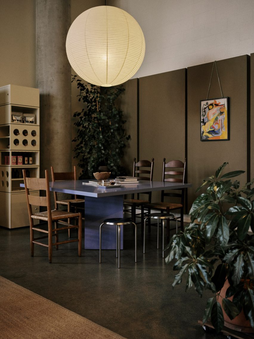 Coffee shop with a custom blue table below a spherical paper lantern